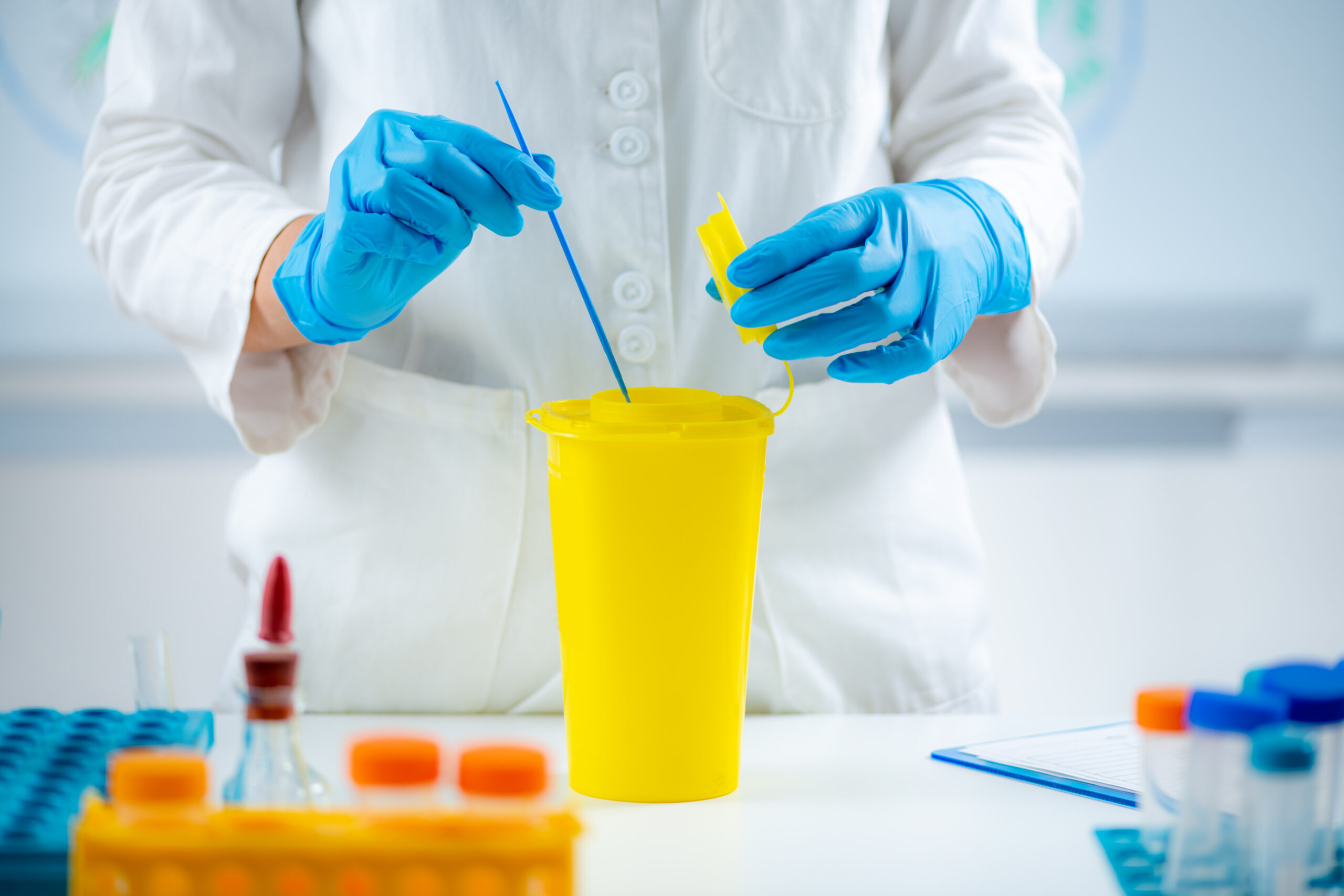 Medical Waste. Throwing Away Medical Waste in Container for Hazardous Medical Waste.